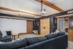 Lower level home theater has a Roku Smart TV set up on the projector